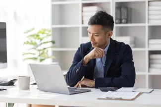 Asian businessman sitting at his desk working