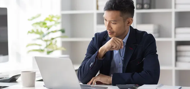 Asian businessman sitting at his desk working